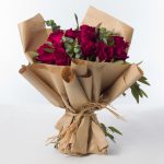 Red roses wrapped with vintage brown papers.