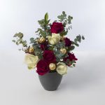 A bouquet that contains red and white flowers in a vase.